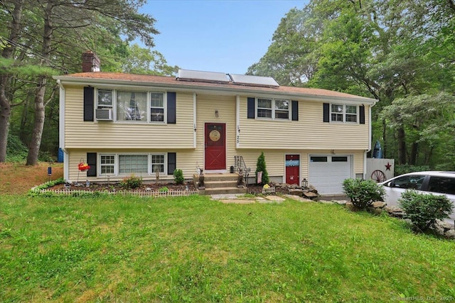 25 Ridgewood Rd, Willington, CT 06279 - raised ranch featuring a garage, a chimney, a front yard, and driveway