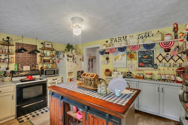 25 Ridgewood Rd, Willington, CT 06279 - kitchen with black range with electric stovetop, white refrigerator with ice dispenser, a textured ceiling, stainless steel microwave, and open shelves