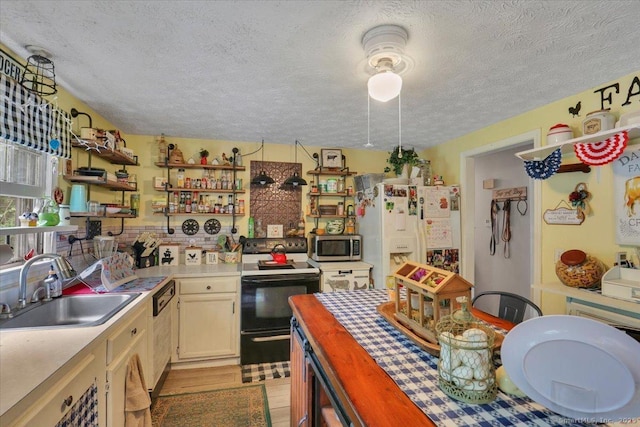 25 Ridgewood Rd, Willington, CT 06279 - kitchen with electric stove, white refrigerator with ice dispenser, stainless steel microwave, a textured ceiling, and open shelves