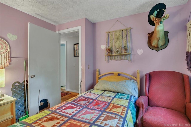25 Ridgewood Rd, Willington, CT 06279 - bedroom featuring a textured ceiling and wood finished floors
