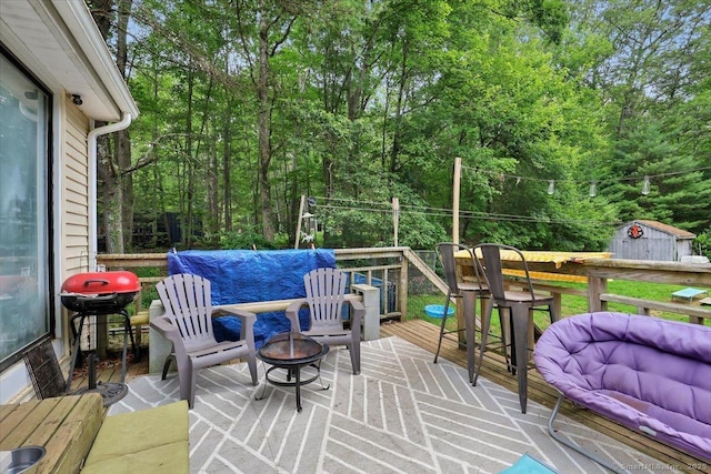 25 Ridgewood Rd, Willington, CT 06279 - deck with an outdoor fire pit, area for grilling, a storage shed, and a wooded view