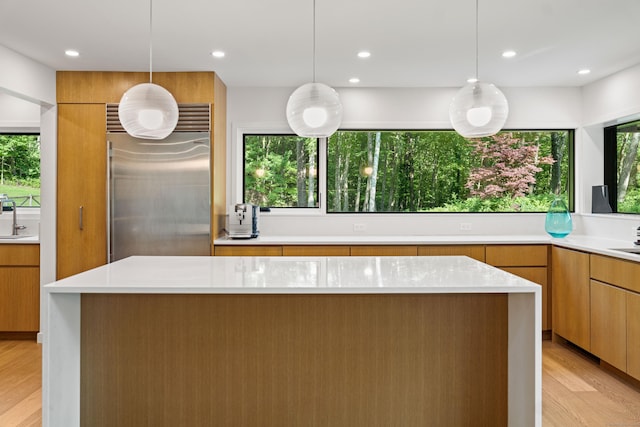 9 Overlook Dr, Salisbury, CT 06039 - kitchen featuring stainless steel built in refrigerator, light wood-type flooring, light countertops, modern cabinets, and pendant lighting