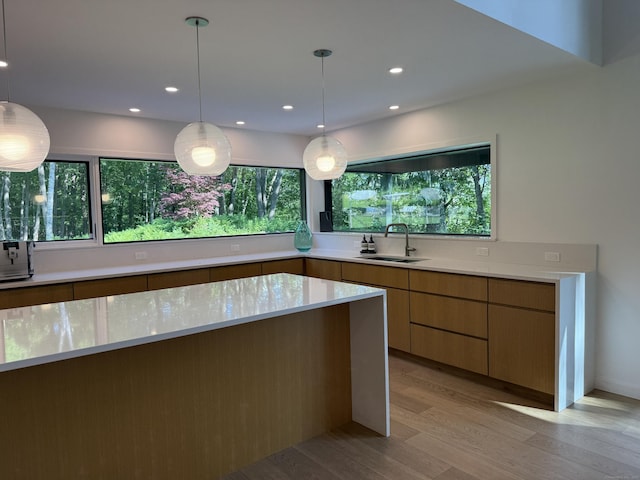 9 Overlook Dr, Salisbury, CT 06039 - kitchen featuring light wood-style floors, modern cabinets, decorative light fixtures, recessed lighting, and light stone counters