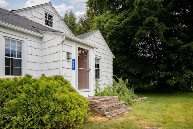 367 Norfolk Rd, North Canaan, CT 06024 - view of exterior entry featuring roof with shingles and a lawn
