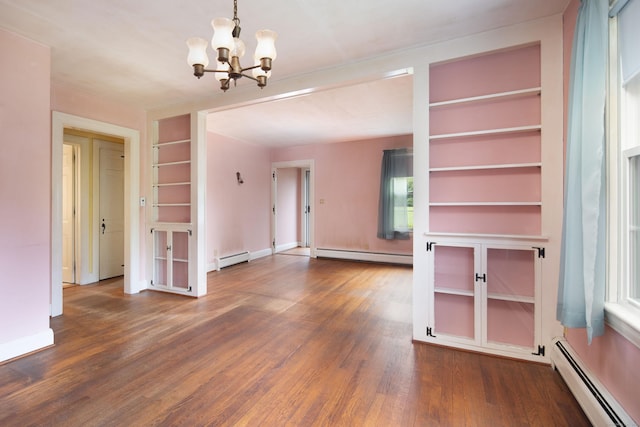 367 Norfolk Rd, North Canaan, CT 06024 - empty room featuring a baseboard radiator, baseboard heating, built in features, and a chandelier