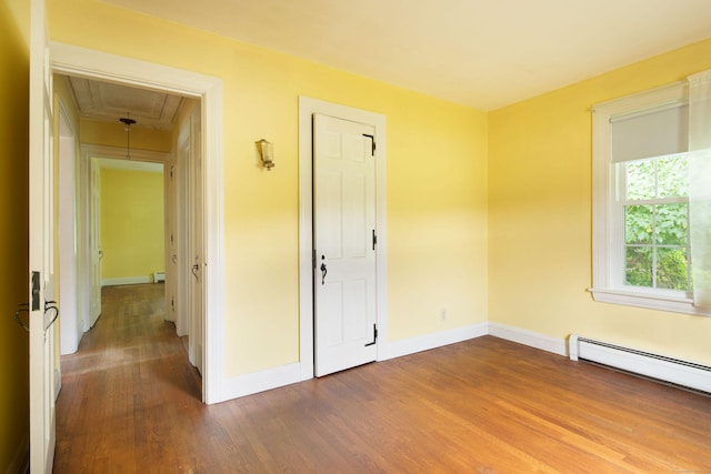 367 Norfolk Rd, North Canaan, CT 06024 - unfurnished room featuring attic access, wood finished floors, and a baseboard heating unit