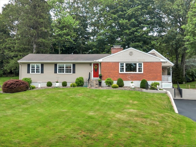 266 Ballfall Rd, Middletown, CT 06457 - ranch-style house featuring a front lawn, a chimney, brick siding, and view of scattered trees