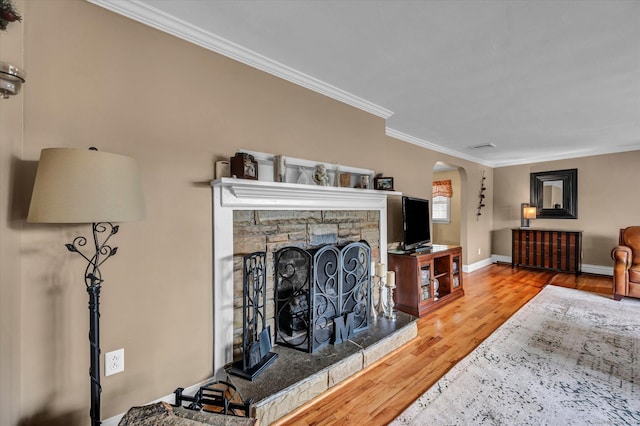 266 Ballfall Rd, Middletown, CT 06457 - living area with wood finished floors, arched walkways, ornamental molding, and a stone fireplace