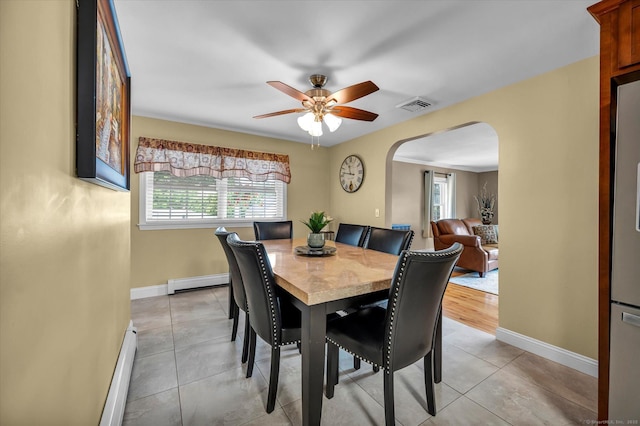 266 Ballfall Rd, Middletown, CT 06457 - dining space featuring arched walkways, a baseboard radiator, a baseboard heating unit, ceiling fan, and light tile patterned floors