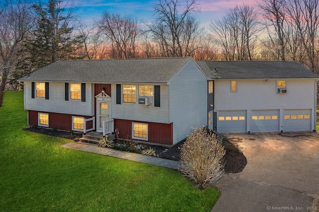 31 Bob White Way, Plainfield, CT 06354 - split foyer home featuring driveway, an attached garage, a lawn, and cooling unit