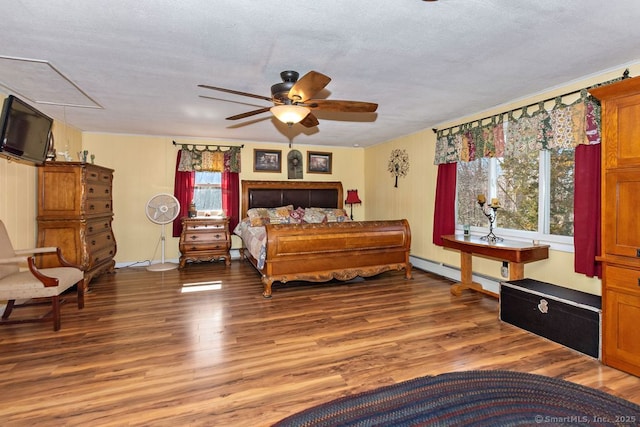 31 Bob White Way, Plainfield, CT 06354 - bedroom featuring attic access, multiple windows, wood finished floors, baseboard heating, and a textured ceiling