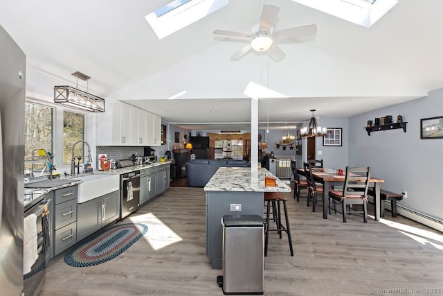 31 Bob White Way, Plainfield, CT 06354 - kitchen with a skylight, dishwasher, a kitchen bar, high vaulted ceiling, and light wood finished floors