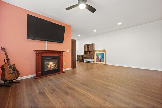 1060 New Haven Ave Apt 7, Milford, CT 06460 - unfurnished living room featuring a glass covered fireplace, a ceiling fan, wood finished floors, and recessed lighting