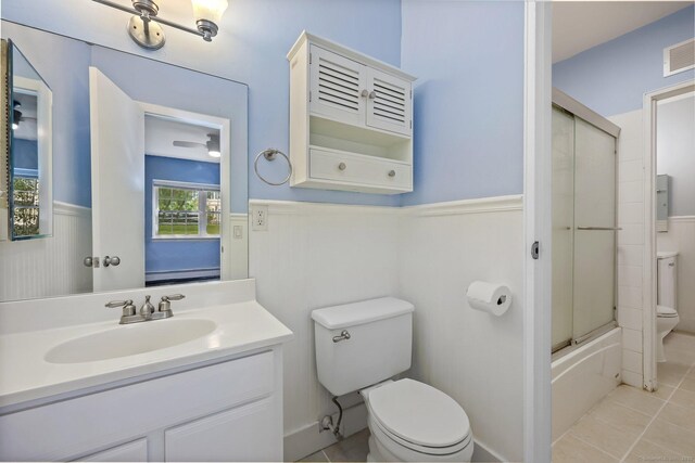 1060 New Haven Ave Apt 7, Milford, CT 06460 - bathroom with wainscoting, tile patterned flooring, vanity, and shower / bath combination with glass door
