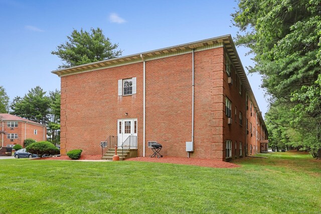 1060 New Haven Ave Apt 7, Milford, CT 06460 - back of property with entry steps, a yard, and brick siding