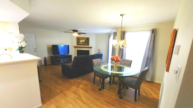 59 Leafwood Ln Apt 275, Groton, CT 06340 - dining room featuring a chandelier, wood finished floors, a fireplace, and ceiling fan