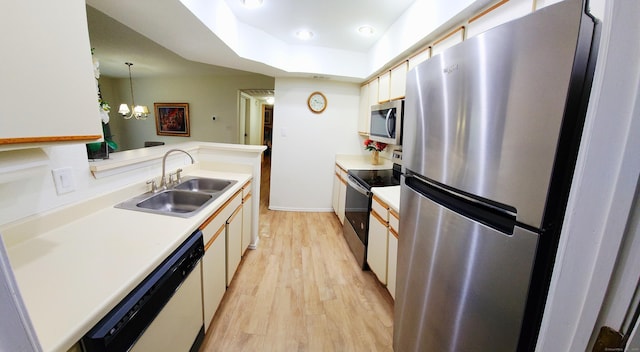 59 Leafwood Ln Apt 275, Groton, CT 06340 - kitchen with stainless steel appliances, light wood-style floors, light countertops, decorative light fixtures, and a chandelier