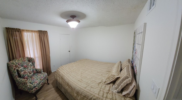59 Leafwood Ln Apt 275, Groton, CT 06340 - bedroom with wood finished floors and a textured ceiling