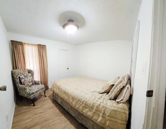 59 Leafwood Ln Apt 275, Groton, CT 06340 - bedroom featuring light wood-type flooring and a textured ceiling