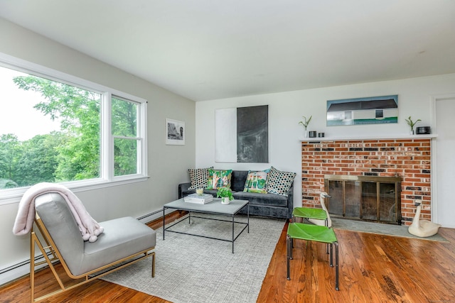 23 Bell Hill Rd, Washington, CT 06793 - living area featuring wood finished floors, baseboard heating, and a brick fireplace
