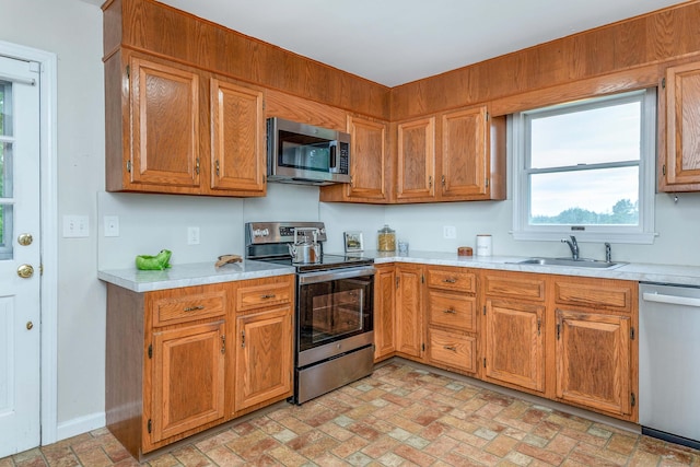 23 Bell Hill Rd, Washington, CT 06793 - kitchen featuring stainless steel appliances, brick patterned floors, light countertops, and brown cabinets