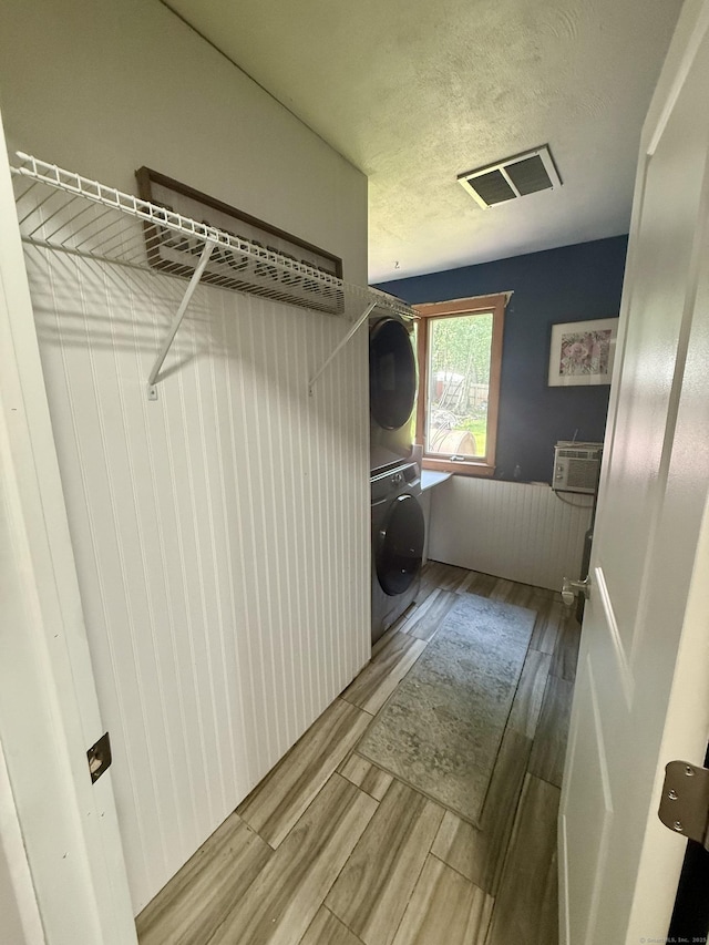 13 Myrna Dr, Marlborough, CT 06447 - washroom featuring stacked washer / drying machine, wood finished floors, a textured ceiling, and a wall mounted AC