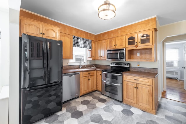 6 French St, Bristol, CT 06010 - kitchen featuring stainless steel appliances, healthy amount of natural light, dark countertops, glass insert cabinets, and ornamental molding