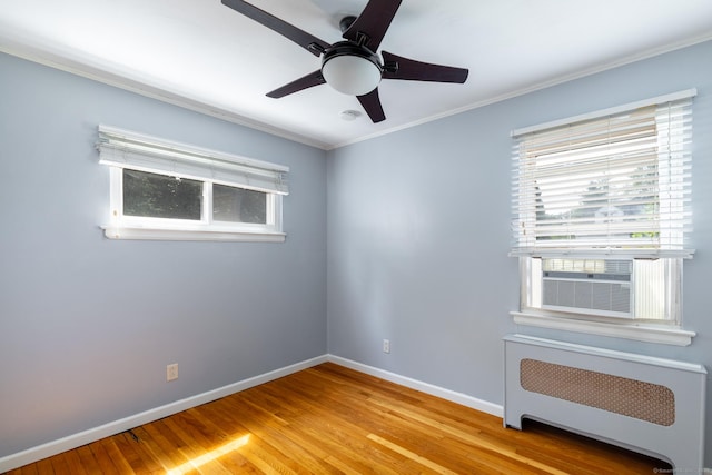 6 French St, Bristol, CT 06010 - empty room featuring radiator, ornamental molding, light wood-type flooring, healthy amount of natural light, and a ceiling fan