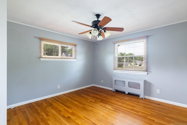 6 French St, Bristol, CT 06010 - empty room featuring radiator, ornamental molding, healthy amount of natural light, wood finished floors, and ceiling fan
