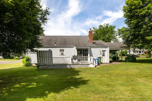6 French St, Bristol, CT 06010 - back of property featuring a lawn, a wooden deck, an attached carport, and a chimney