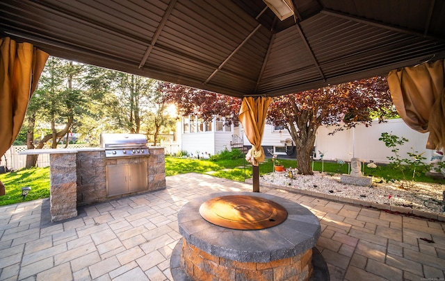 44 Middle Tpke E, Manchester, CT 06040 - fenced backyard with a fire pit, exterior kitchen, a patio area, and a gazebo