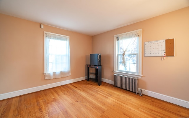 44 Middle Tpke E, Manchester, CT 06040 - empty room with radiator, plenty of natural light, and wood finished floors