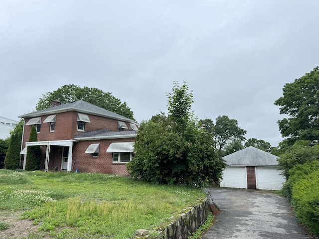 605 Laurel Hill Rd, Norwich, CT 06360 - view of property exterior with a detached garage, an outbuilding, brick siding, and a chimney