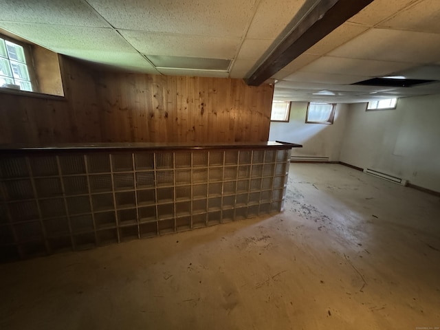 605 Laurel Hill Rd, Norwich, CT 06360 - basement featuring wood walls, baseboard heating, a dry bar, and a paneled ceiling