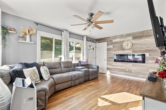 4 Warfield St, Milford, CT 06461 - living area featuring wooden walls, ceiling fan, wood finished floors, and an accent wall