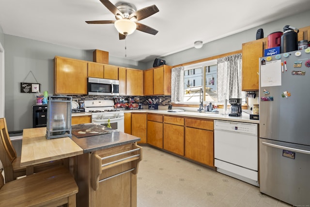 4 Warfield St, Milford, CT 06461 - kitchen featuring appliances with stainless steel finishes, ceiling fan, backsplash, and light countertops