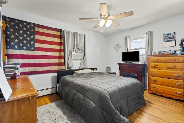 4 Warfield St, Milford, CT 06461 - bedroom with baseboard heating, wood finished floors, cooling unit, and ceiling fan