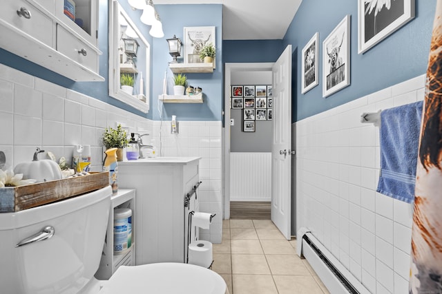 4 Warfield St, Milford, CT 06461 - bathroom featuring tile walls, tile patterned flooring, vanity, a wainscoted wall, and a baseboard radiator