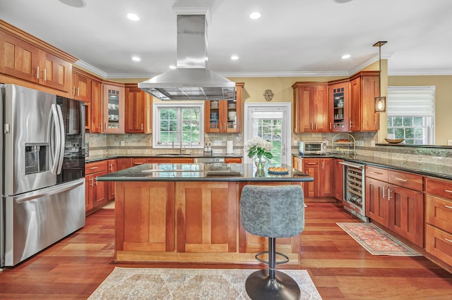 19 Woodlawn Dr, Trumbull, CT 06611 - kitchen featuring appliances with stainless steel finishes, island range hood, wine cooler, wood finished floors, and crown molding