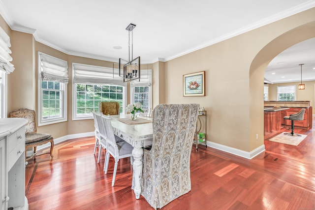 19 Woodlawn Dr, Trumbull, CT 06611 - dining space with arched walkways, a chandelier, wood finished floors, crown molding, and recessed lighting