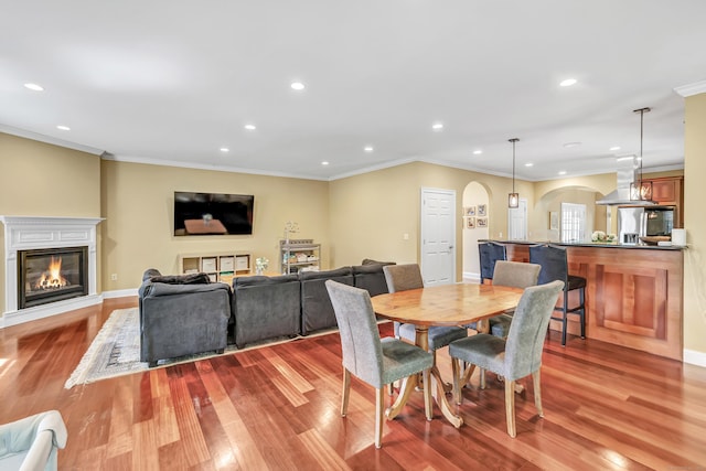 19 Woodlawn Dr, Trumbull, CT 06611 - dining space with arched walkways, a glass covered fireplace, recessed lighting, wood finished floors, and ornamental molding