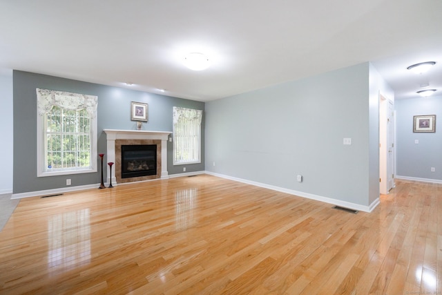 130 Bird Rd, Bristol, CT 06010 - unfurnished living room with light wood-style flooring and a fireplace