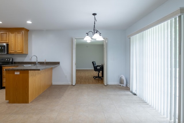 130 Bird Rd, Bristol, CT 06010 - kitchen with range, a peninsula, stainless steel microwave, dark countertops, and recessed lighting