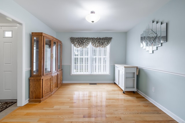 130 Bird Rd, Bristol, CT 06010 - unfurnished dining area featuring light wood-type flooring and baseboards