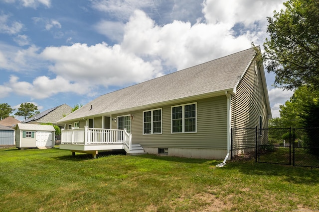 130 Bird Rd, Bristol, CT 06010 - back of property with a storage unit, a gate, a deck, and roof with shingles