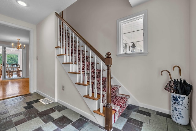 7 Sharon Ln, Old Saybrook, CT 06475 - stairs with stone tile floors and a chandelier