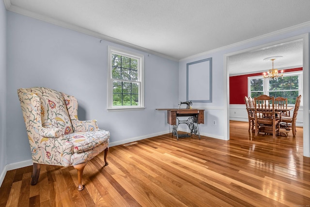 7 Sharon Ln, Old Saybrook, CT 06475 - living area with ornamental molding, a chandelier, wood finished floors, and a textured ceiling