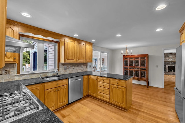 7 Sharon Ln, Old Saybrook, CT 06475 - kitchen featuring appliances with stainless steel finishes, a peninsula, a chandelier, tasteful backsplash, and recessed lighting