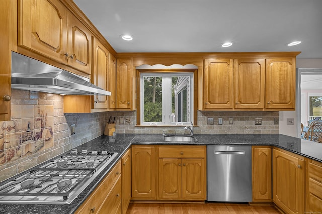 7 Sharon Ln, Old Saybrook, CT 06475 - kitchen with stainless steel appliances, under cabinet range hood, dark stone countertops, tasteful backsplash, and recessed lighting
