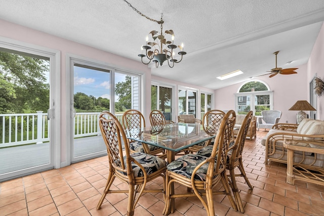 7 Sharon Ln, Old Saybrook, CT 06475 - dining room with healthy amount of natural light, a textured ceiling, vaulted ceiling, a chandelier, and a ceiling fan